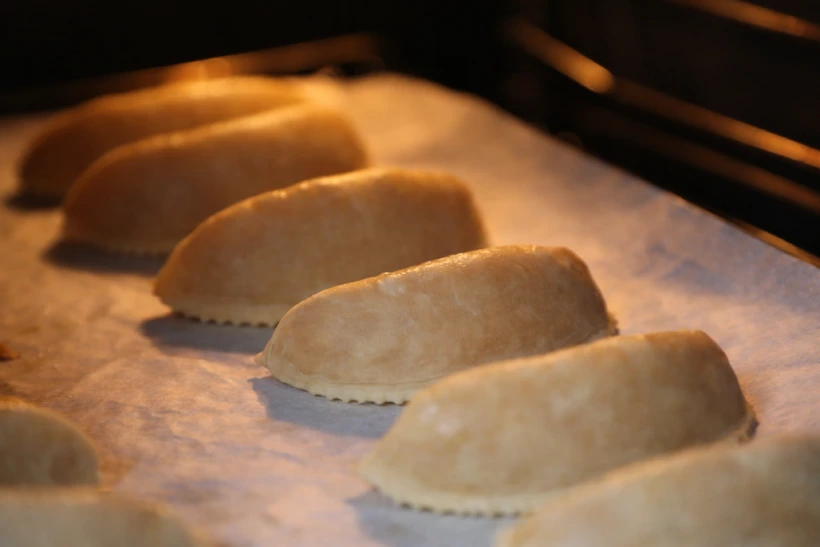 Corne de gazelle baking in the oven, remaining pale and lightly set without browning