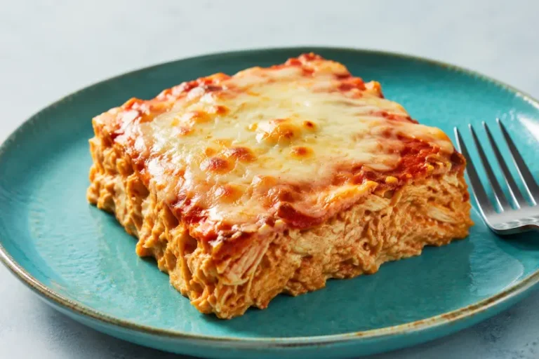 Bariatric chicken enchilada bake portion with visible shredded chicken and melted cheese